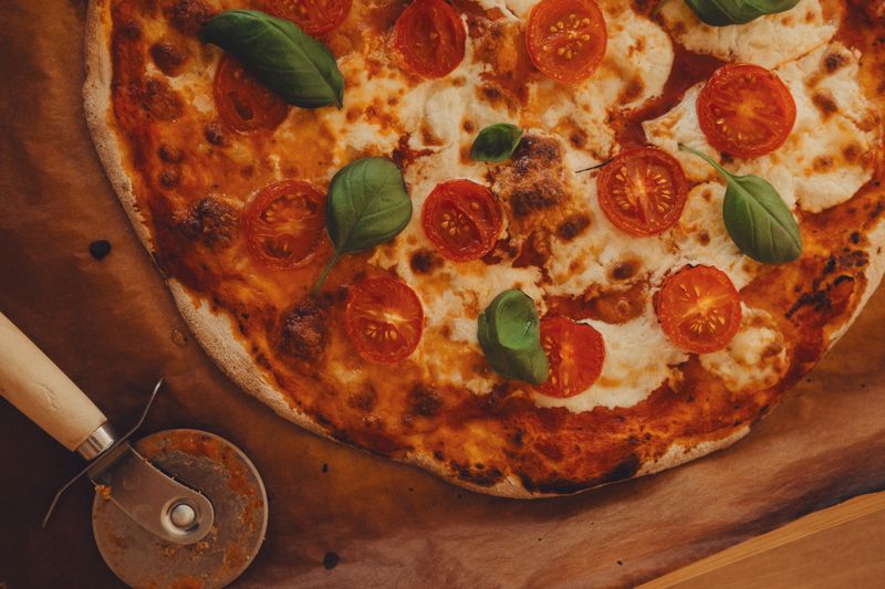 Prosciutto arugula punch pizza with shaved parmesan finish