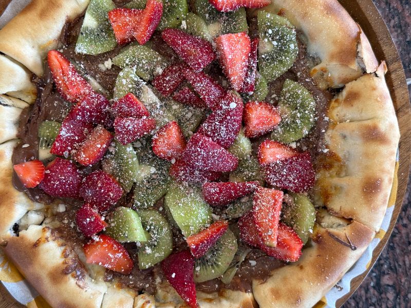 Punch pizza kitchen — artisan pizza being crafted by hand