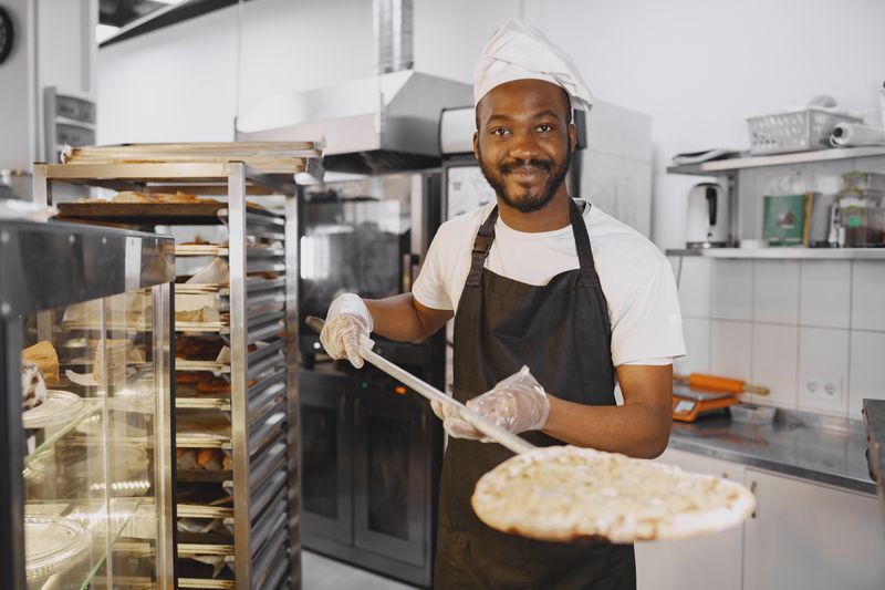 Skilled pizza artist spinning dough at Punch pizza