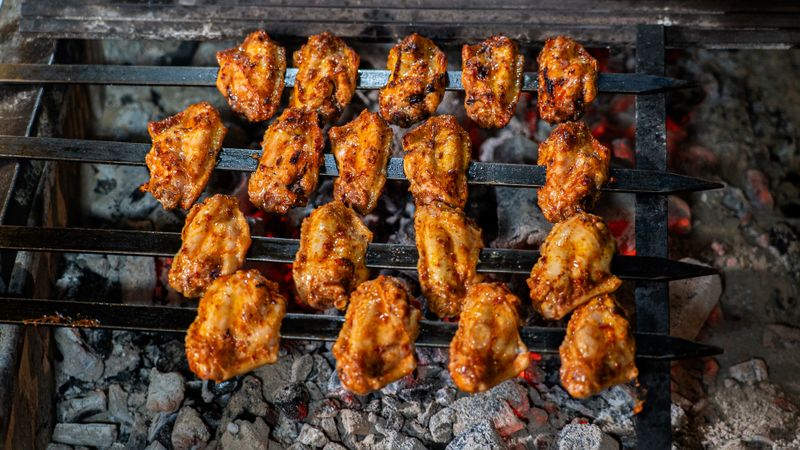 Smoky BBQ chicken punch pizza with red onions and cilantro