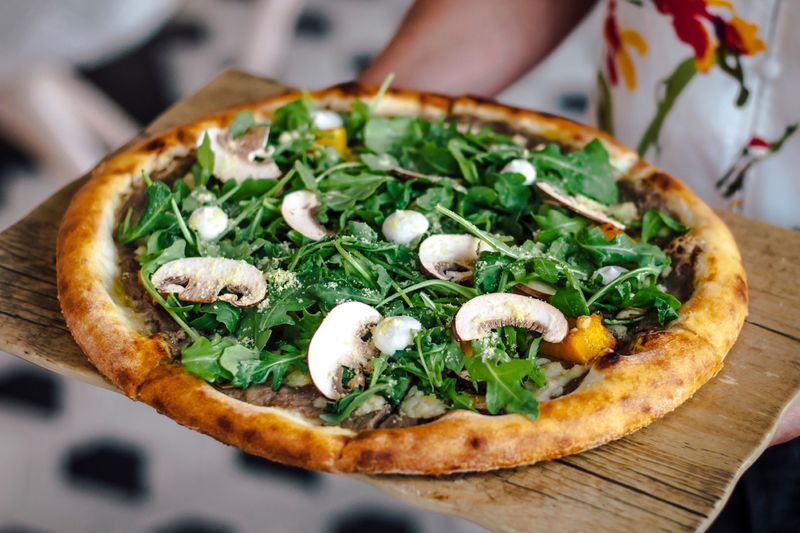 Spicy arrabbiata punch pizza with chili flakes and fresh herbs